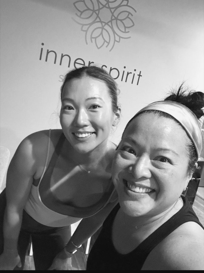 Two teachers smiling together in the studio.